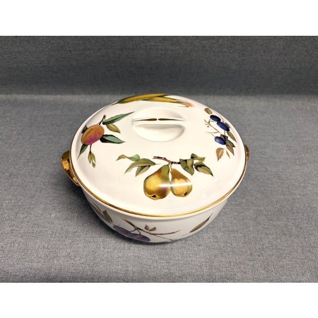 A Royal Worcester Evesham Covered Casserole Dish, decorated in a striking fruit and veg motif. The casserole bowl is Royal...