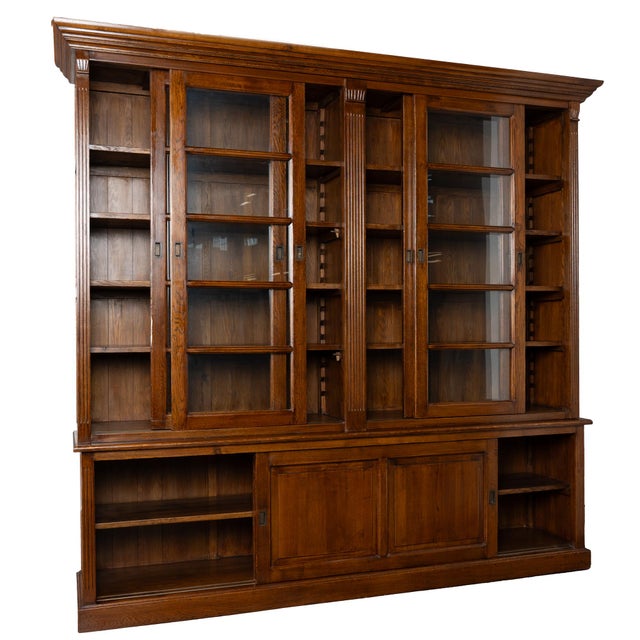 20th century Danish bookcase crafted in oak. The upper section features four glass doors, each sliding independently,...