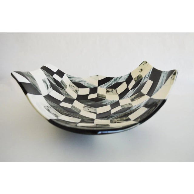 This is a centerpiece in ivory and black Murano glass, in a hexagonal and sinuous shape. Signed by Maker,Labeled by...