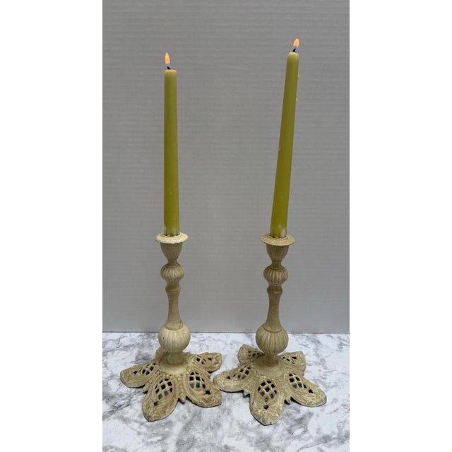 Farmhouse cottage style pair of iron candleholders with open pattern design on the base. Holds standard taper candles. Set...