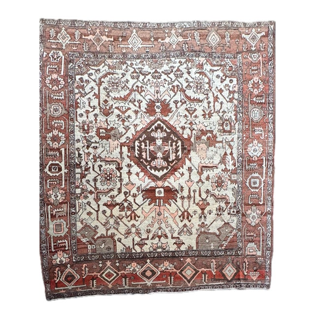 A striking antique Heriz rug, hand-knotted in northwest Persia circa early 20th century. Measuring approximately 9'11" x...