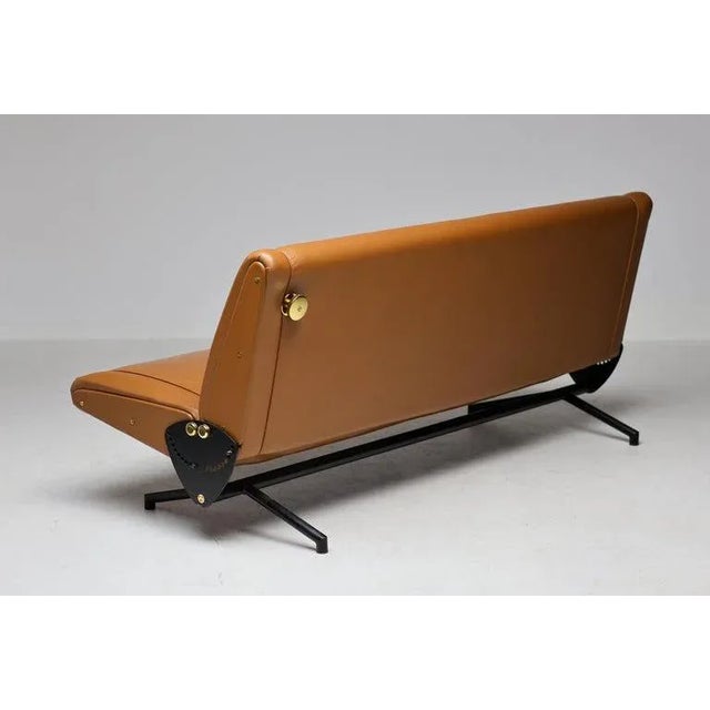 Osvaldo borsani for tecno sofa ‘d70’, enameled steel base, brass hardware, cognac leather upholstery. Osvaldo borsani’s...