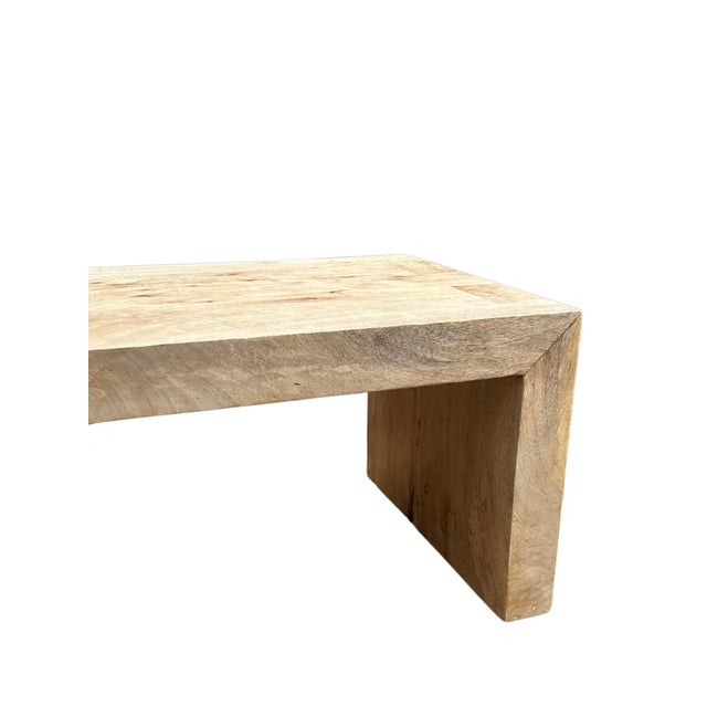 The bench was sculpted from solid mango wood. The wood used to create this bench is reclaimed. It features a natural...