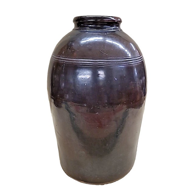 Exceptional antique stoneware storage jar by the Peoria Pottery Company, dating from approximately 1864–1902. This...