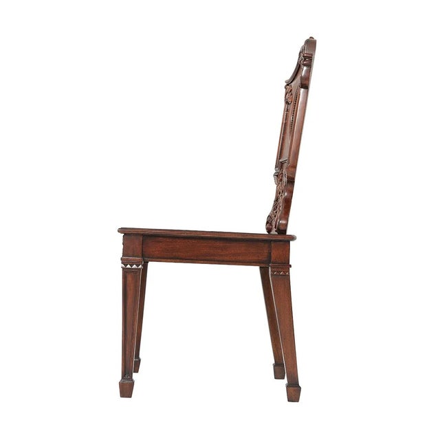A finely carved mahogany chair, the arched cartouche backrest with carved acanthus leaf details centered by the hand-...