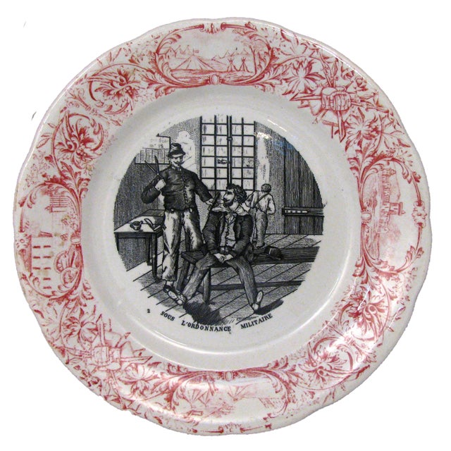 Two red transferware plates with a military theme from the prestigious Digoin & Sarreguemines porcelain workshop. A lovely...