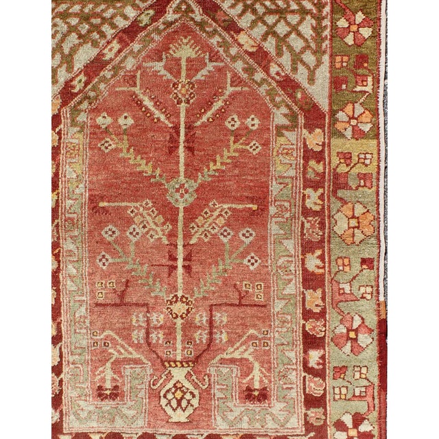Antique Oushak Rug From Turkey With Directional Tribal Motifs in Soft Pink Red, Green. Antique Oushak Rug Turkey with Tree...