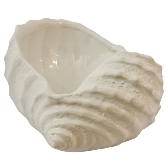 Bring a touch of the Italian coast into your home with this exquisite glazed ceramic conch shell bowl, sourced directly...