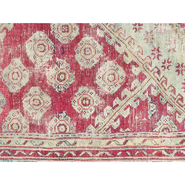 This beautiful vintage Turkish Oushak Rug is hand-knotted with 100% wool on a wool foundation to provide a soft, warm...