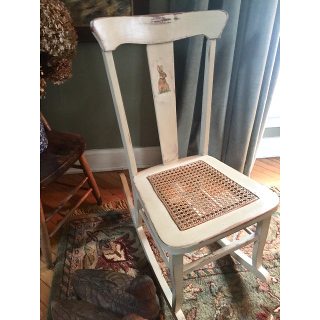 Lovingly finished, in antique white with bunny appliqué. Perfect cane seat