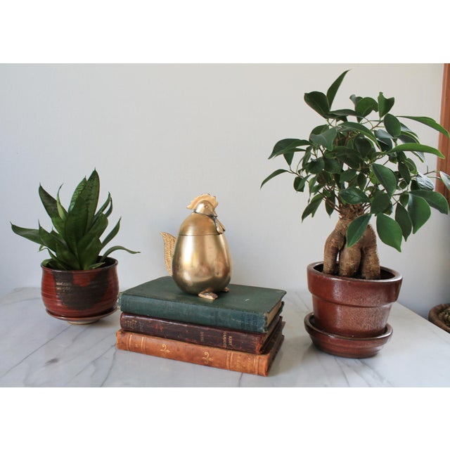Vintage polished brass egg-shaped container with a rooster or hen head lid. Minor age wear.