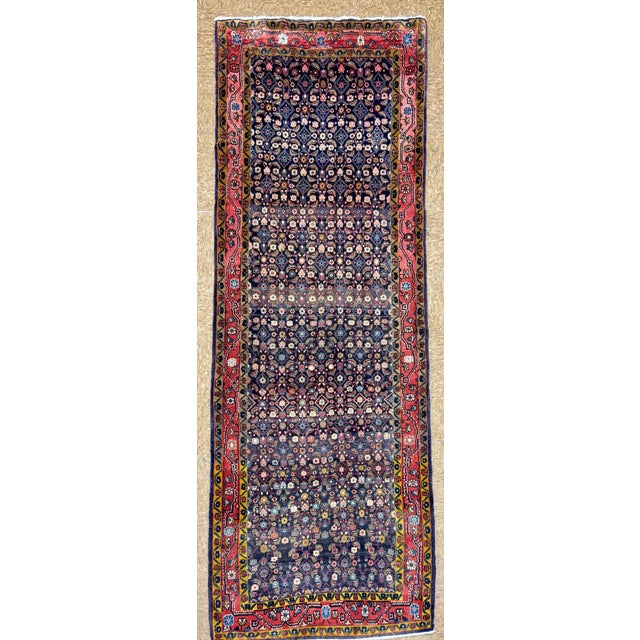 Hand-knotted runner from the Zanjan region of northwest Iran, featuring a dense allover Herati (fish) pattern set within a...