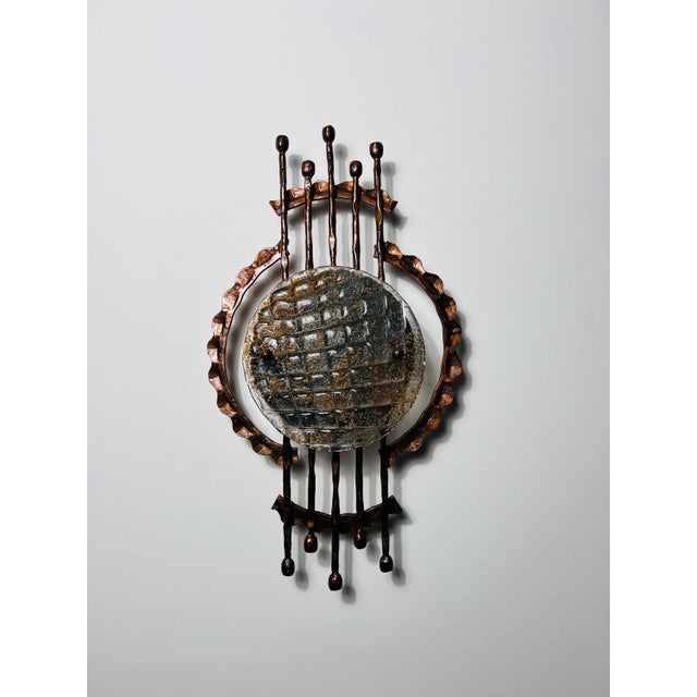 This striking Brutalist wall lamp from the 1970s is a bold example of the raw, industrial aesthetic that defines the...