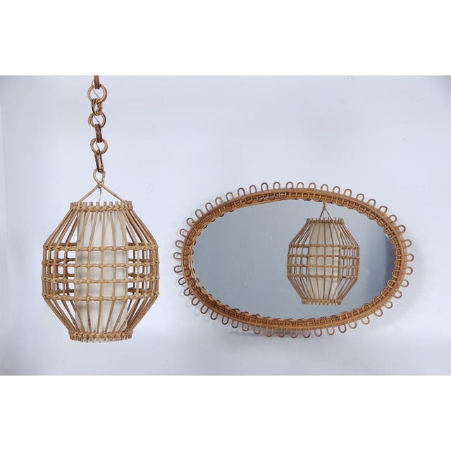 Interesting set composed of mirror and chandelier made of bamboo. About 1960s set, they do not report any brand but the...
