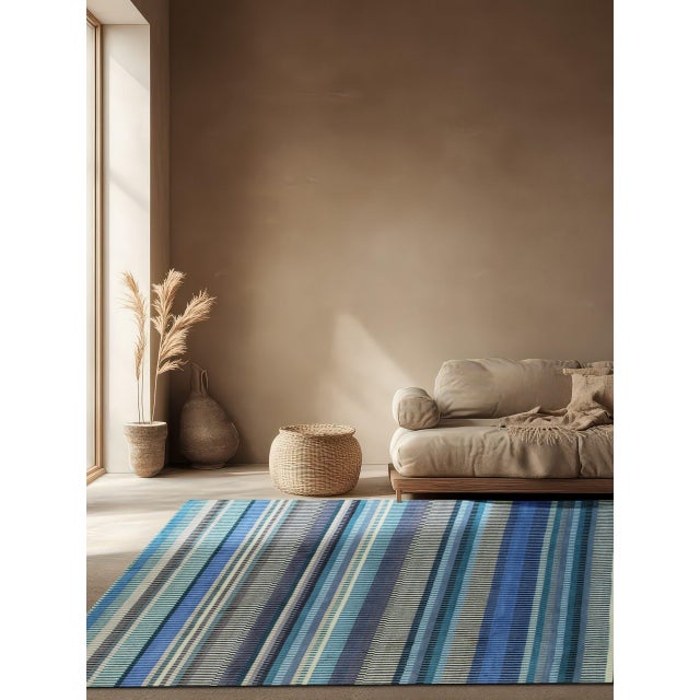 Louie Ophelia Ocean Blue Handmade Wool Rug, Country of Origin: India. This contemporary piece offers a dynamic, abstract...