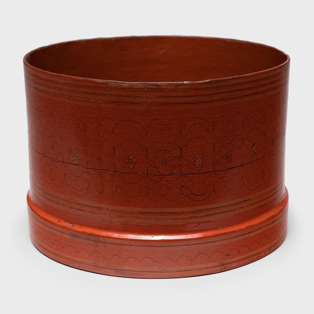 This intricately decorated red lacquer container is the lower portion of an early 20th century Burmese betel box (kun-it)....