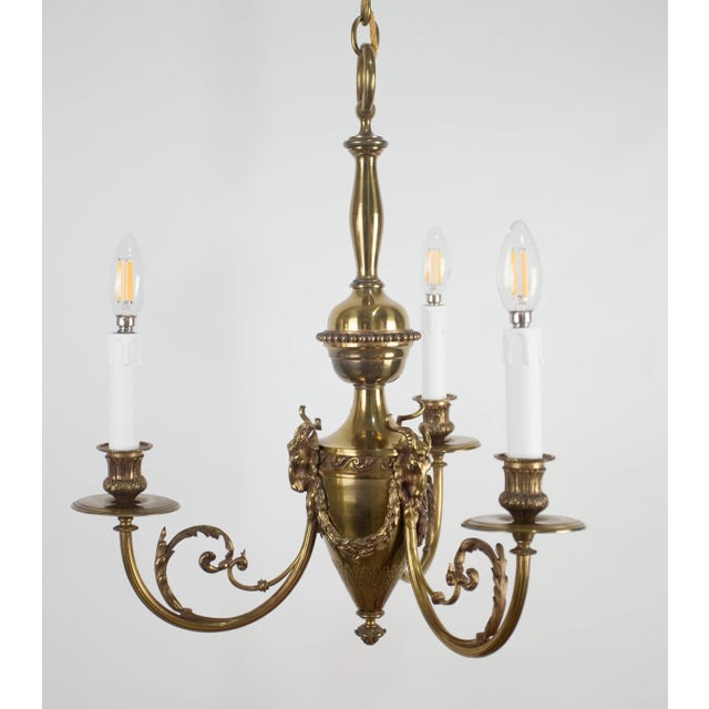 An elegant brass chandelier from around 1960 impresses with its precise workmanship and rich plastic decoration. The...