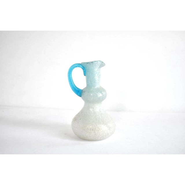 A vintage Venetian, Murano glass small bud vase in the form of a tiered pitcher, with a froth of bullicante small bubbles...
