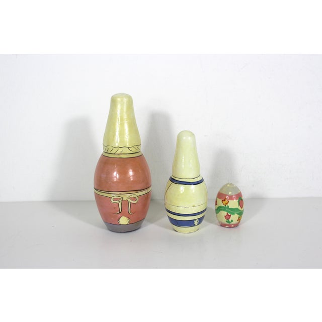 Vintage hand painted wood stacking dolls in the shape of two Easter bunny rabbits and an egg. Great vintage patina and a...