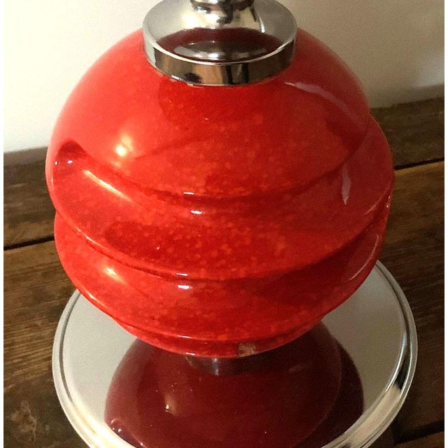 A rare 1970s table lamp made by the Belgian company Massive. Featuring a bright vermillion ceramic column in two parts and...