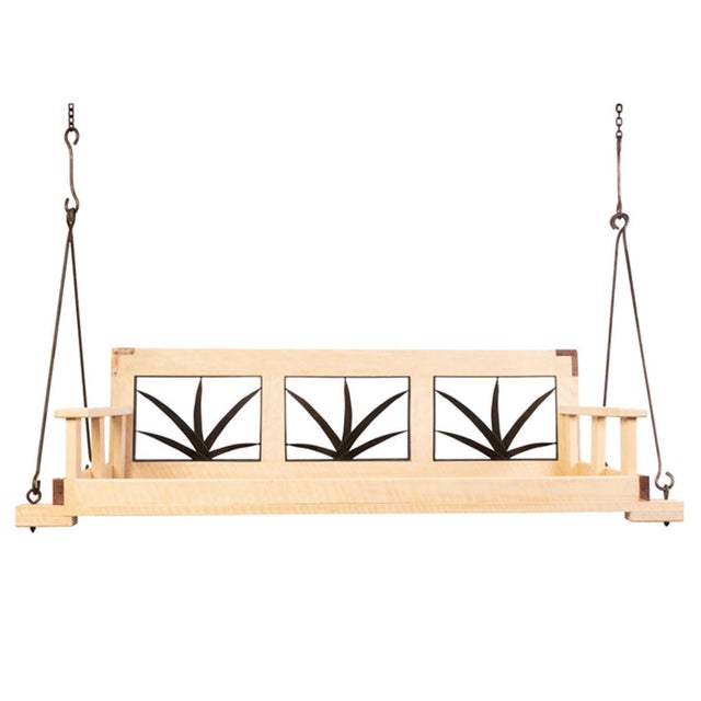The Southern-style deep seated swinging day bed boasts a palmetto leaf design with beverage holders on each armluxury and...