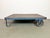 Former pallet truck from a factory now serves as a coffee table. It features a blue iron construction with two original...