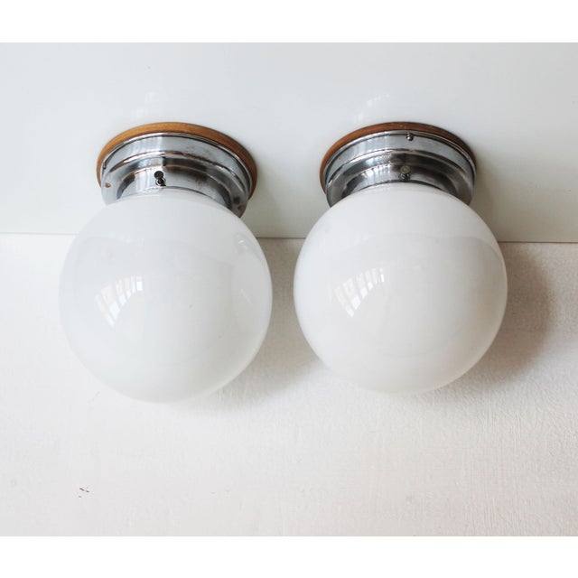 This original pair of ceiling or wall lamps dates from the 1930s and represents a rare surviving example of early...