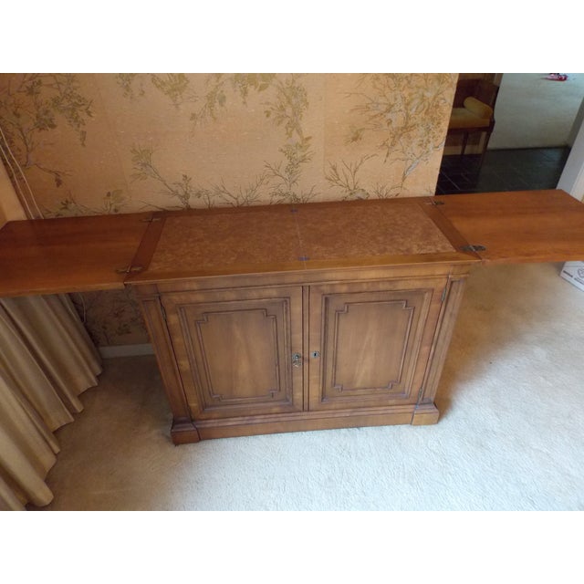 A gorgeous French Regency Louis XVI style flip-top rolling buffet server or bar cabinet by Kindle Furniture USA. Carved...