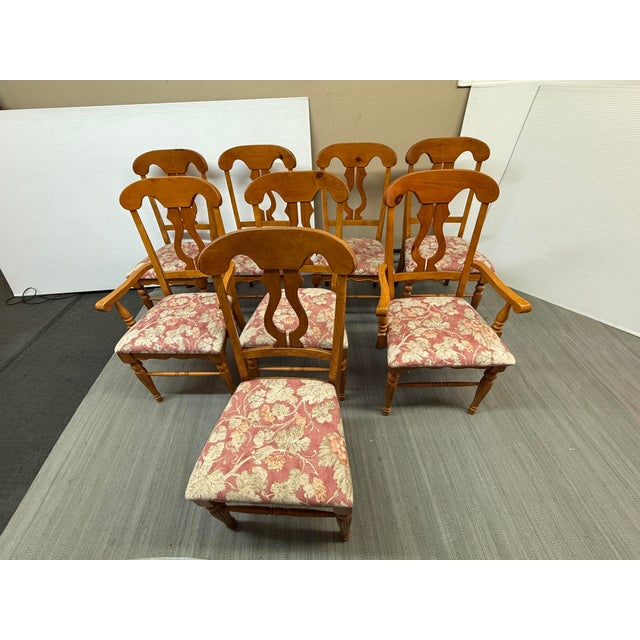 Design Plus Gallery presents a Set of Eight Fiddleback Splat Vintage Dining Chairs. The chairs have a medium, honey brown...