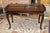 This is a heavy & sturdy table. I believe it to be mahogany. Divided, gallery edge, top. Single drawer with brass...