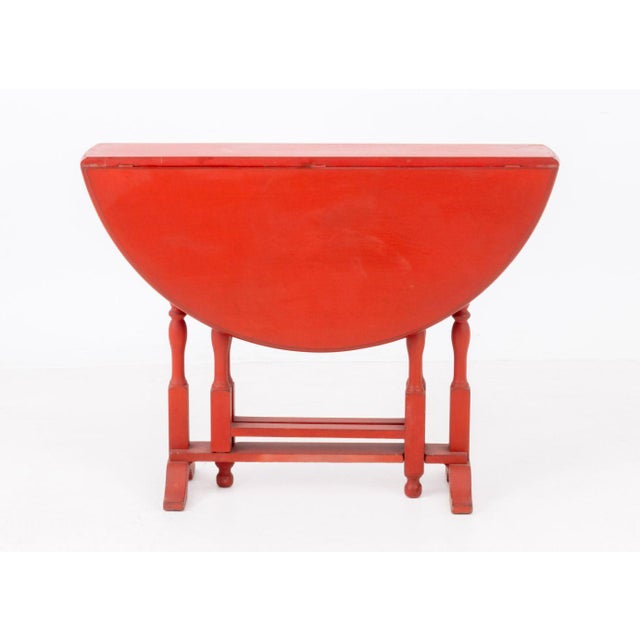 George III Style Red Painted Circular Drop Leaf Table, with two gate legs. 30" H x 40" W x 9.75" D. Provenance: From a...