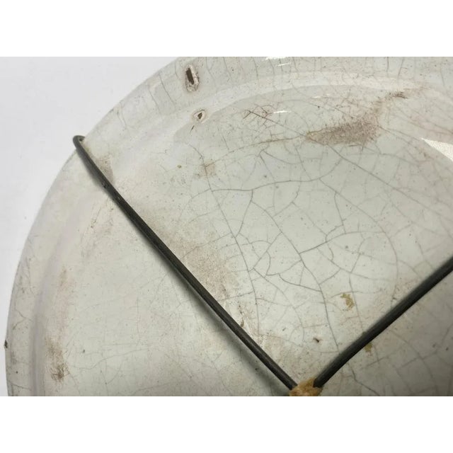 This plate is in Faïence. It has been made in France in the 18th Century. The color are brown and green.