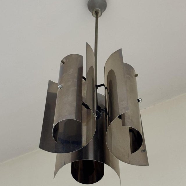 Max Sauze Style Chrome Steel Chandelier, 1970s. Curved chrome-plated steel chandelier in the style of Max Sauze. Six light...
