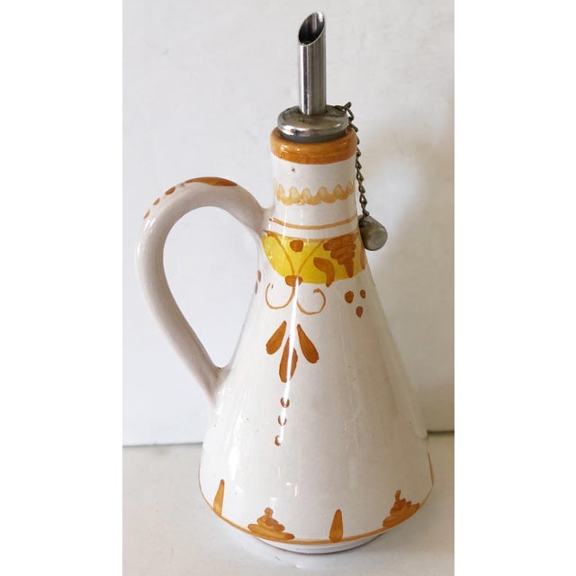 The Italians know how to care for olive oil as evidenced with this decanter. The pottery vessel keeps light away from the...