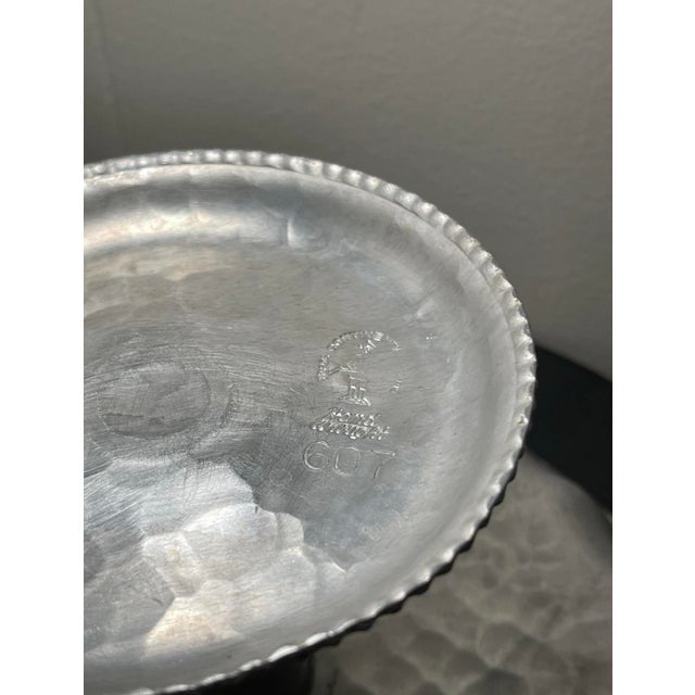 Aluminum compote tray with a mum flower design. A unique piece of handcrafted metalware. The craftsmanship is evident in...