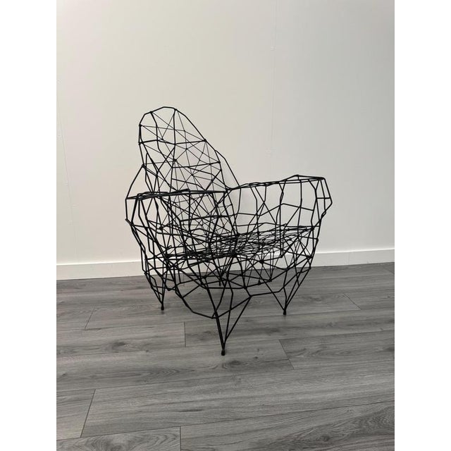 An extraordinary sculptural armchair intricately crafted from iron and string by the acclaimed French artist Gerard...