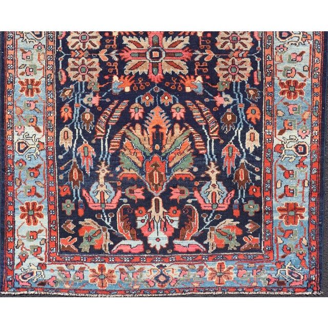 This absolutely stunning Antique Nahavand (circa 1920s) features a symmetrical sub-geometric design rendered in shades of...