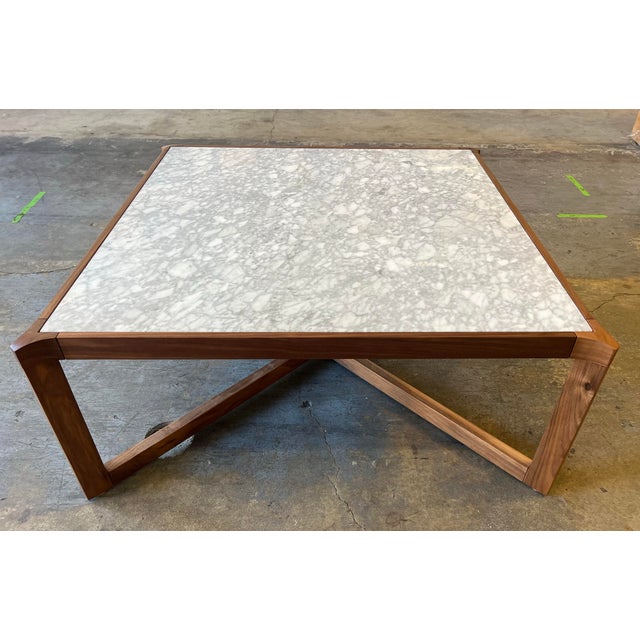 Mid Century Modern coffee table with a newly refinished walnut base with a carerra marble top. The marble is also in...
