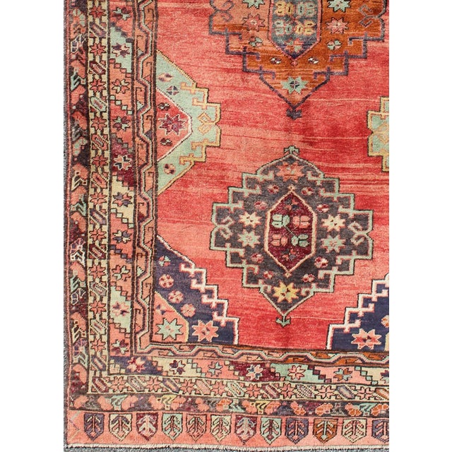 Measures: 4'10 x 9'8. Vintage Turkish Oushak Rug in Bold Coral Red with Navy, Teal, and Burnt Orange. Keivan Woven Arts /...
