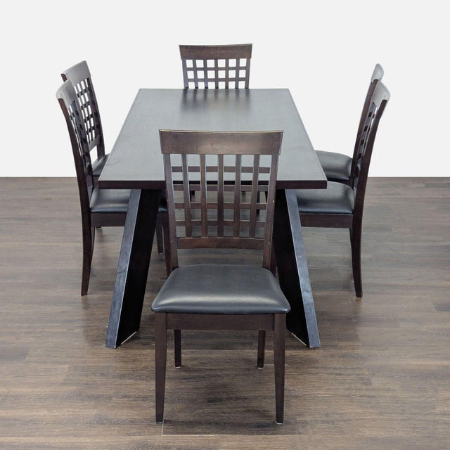 This dining set features a sturdy rectangular table with a modern angled leg design and six comfortable chairs. The dark...