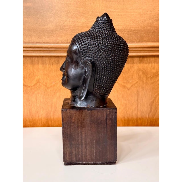 Bronze fragment of a Buddha head in classic U-Thong style on a wood display stand circa 13-15th century from Central...