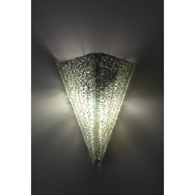Striking pair of sculptural Brutalist wall sconces composed of hundreds of glass shards meticulously wired together to...