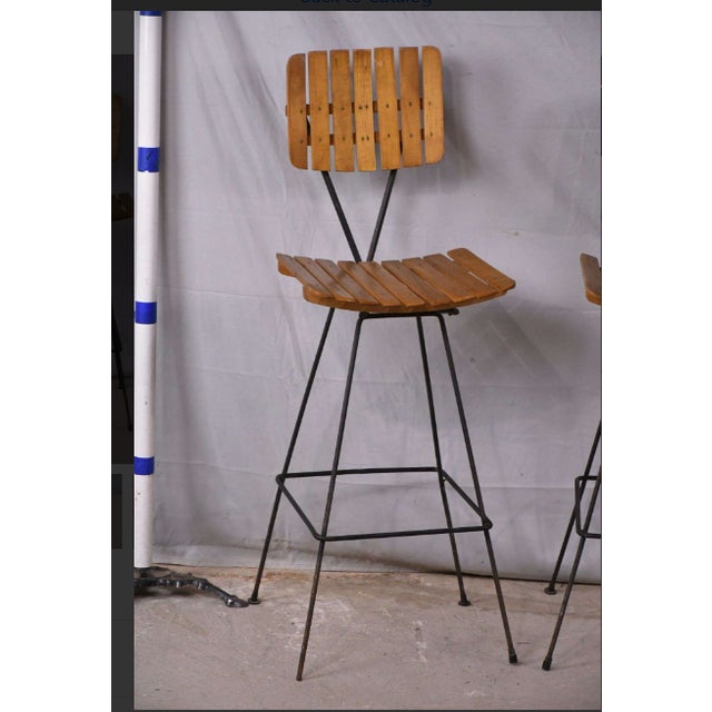 Add timeless Mid-Century Modern style to your space with this striking pair of vintage bar chairs. Designed in the iconic...