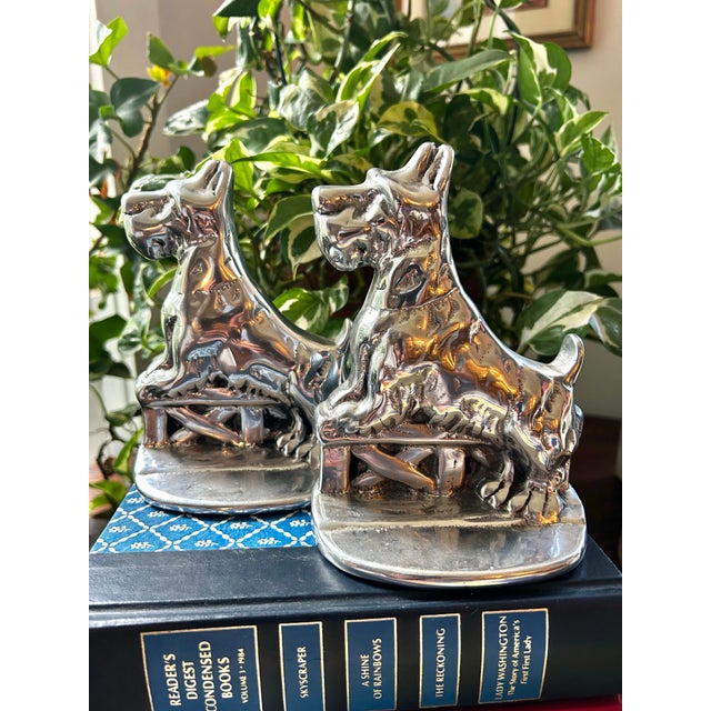 This vintage pair of Hoselton cast aluminum Scottie dog bookends were handcrafted in Canada and signed by the artist. The...