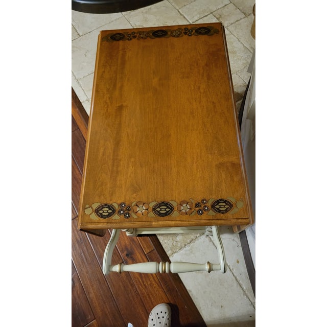 Great vintage dropleaf tea cart with stenciled floral designs. Two leaves and a drawer with the Ethan Allen Mark. It has...