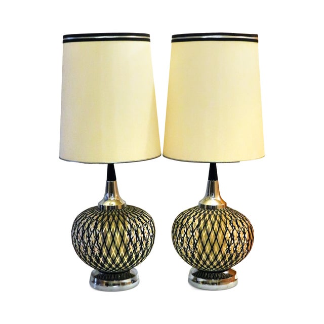 An impressive pair of oversized table lamps featuring spherical globes constructed from layered strands of spun lucite in...
