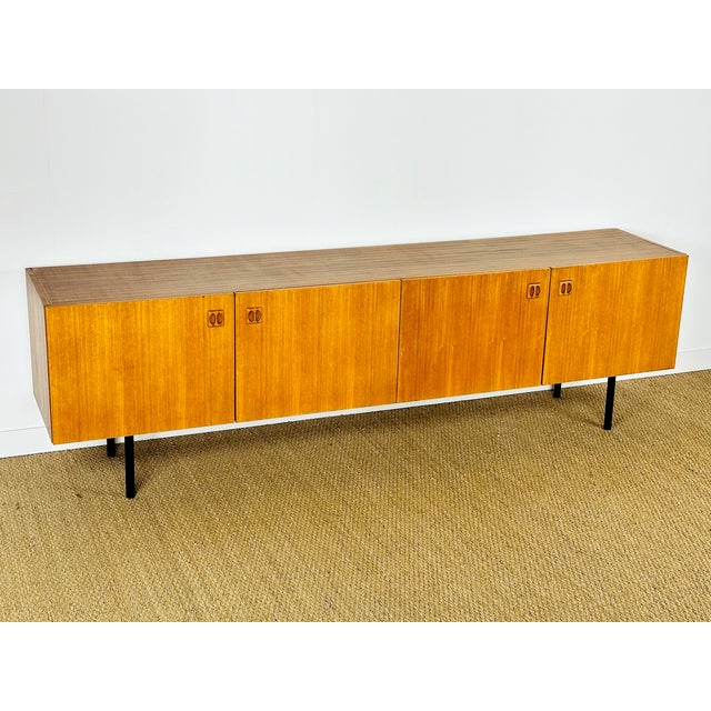 Magnificent vintage Scandinavian teak sideboard dating from the 1960s, featuring four storage doors with shelves. The...