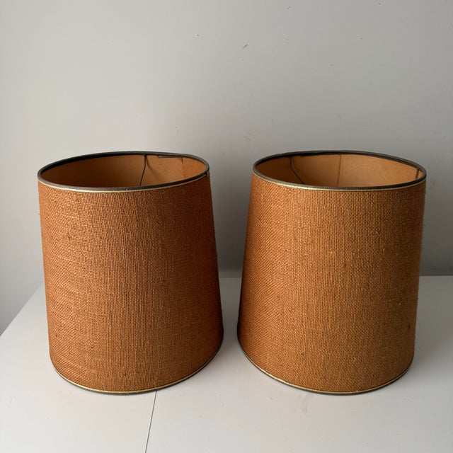 Vintage 1960s burlap barrel lamp shade with thin gold piping accents.