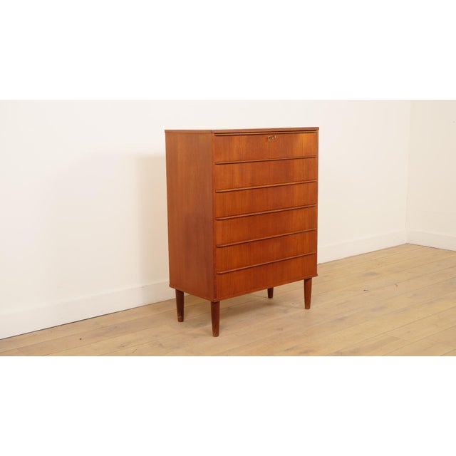 This stylish vintage chest of drawers is a magnificent example of Danish mid-century modern design. Crafted from warm teak...