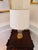 Contemporary Jonathan Y table lamp featuring a stacked clear glass globe and base with brushed brass-finish metal accents...
